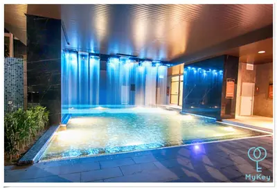 a swimming pool with blue lights in a building at Expressionz Professional Suites by MyKey in Kuala Lumpur