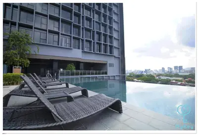 a row of lounge chairs sitting next to a building at Expressionz Professional Suites by MyKey in Kuala Lumpur