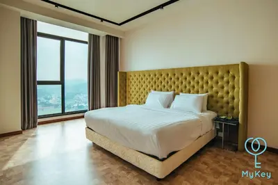 a bedroom with a large bed and a large window at Expressionz Professional Suites by MyKey in Kuala Lumpur