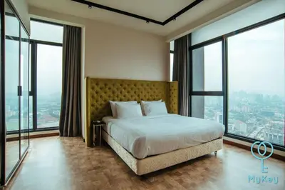 a bedroom with a large bed and large windows at Expressionz Professional Suites by MyKey in Kuala Lumpur