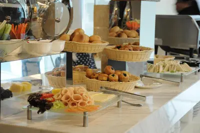 a buffet with baskets of food on a counter at Damas Suites & Residences Kuala Lumpur in Kuala Lumpur