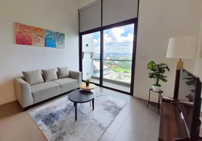 a living room with a couch and a table at KL Sentral, EST Bangsar by SkyLimit Suites in Kuala Lumpur
