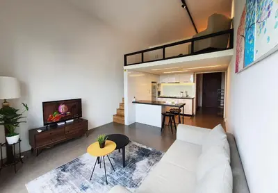 a living room with a couch and a loft bed at KL Sentral, EST Bangsar by SkyLimit Suites in Kuala Lumpur
