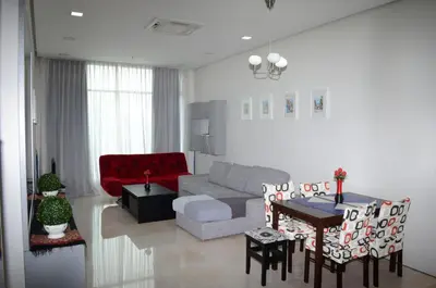 a living room with a couch and a table at Soho Suites KLCC by Elite in Kuala Lumpur