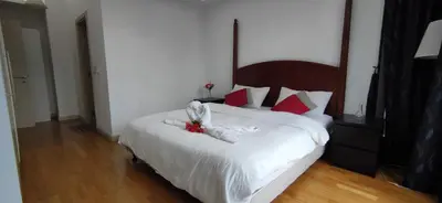 a bedroom with a bed with a stuffed animal on it at 3 Bedroom Cozy apartmet in Kuala Lumpur