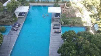 an overhead view of a swimming pool with people in it at 3 Bedroom Cozy apartmet in Kuala Lumpur