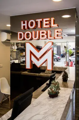 a hotel lobby with a large hotel double sign at Double M Hotel @ Kl Sentral in Kuala Lumpur