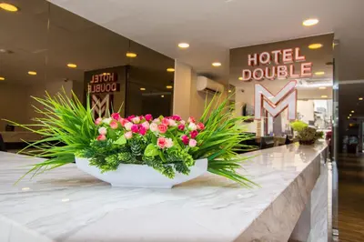 a bouquet of pink flowers on a counter in a hotel lobby at Double M Hotel @ Kl Sentral in Kuala Lumpur