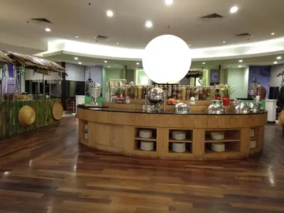 a restaurant with a large white light above a counter at Grand Service Apartment @ Times Square in Kuala Lumpur