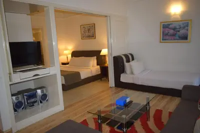 a hotel room with two beds and a television at Grand Service Apartment @ Times Square in Kuala Lumpur