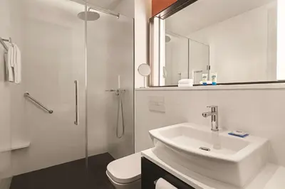 a white bathroom with a sink and a shower at Hyatt House Kuala Lumpur, Mont Kiara in Kuala Lumpur