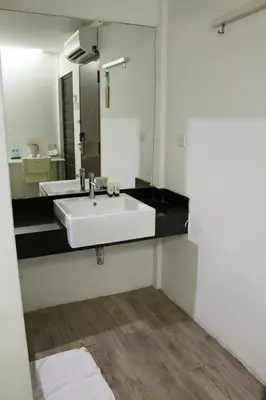 a bathroom with a white sink and a mirror at V Garden Hotel in Kuala Lumpur