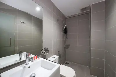 a bathroom with a sink and a toilet and a shower at V Garden Hotel in Kuala Lumpur