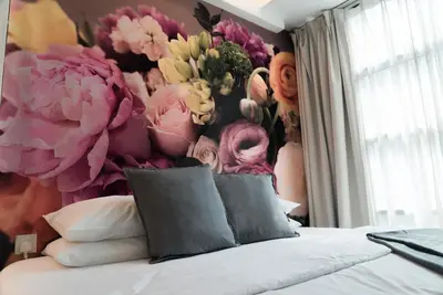 a bedroom with a flower mural on the wall at V Garden Hotel in Kuala Lumpur