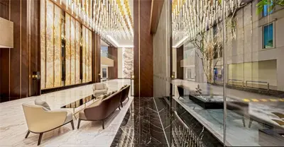 a lobby with chairs and a table in a building at Dorsett Hartamas Kuala Lumpur in Kuala Lumpur