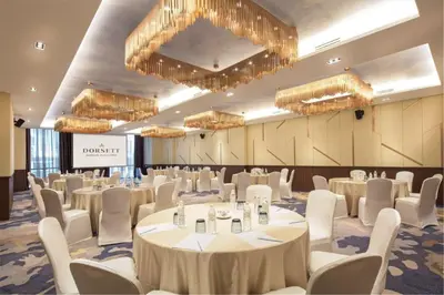 a conference room with tables and chairs and chandeliers at Dorsett Hartamas Kuala Lumpur in Kuala Lumpur
