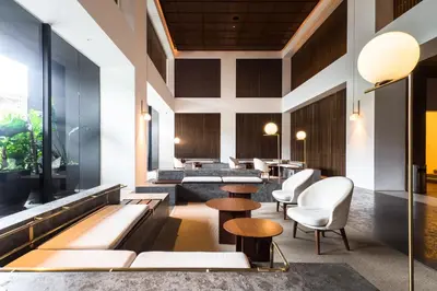 a lobby of a hotel with tables and chairs at EST Suites Bangsar by Airhost in Kuala Lumpur