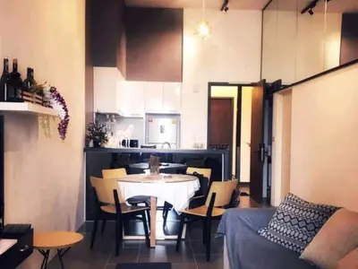a kitchen and a dining room with a table and chairs at Charming Bedroom - next to train station at Est Bangsar in Kuala Lumpur