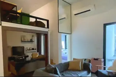 a living room with a couch and a bunk bed at Charming Bedroom - next to train station at Est Bangsar in Kuala Lumpur
