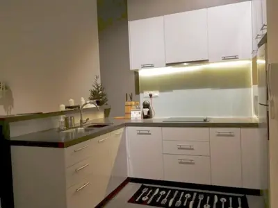 a kitchen with white cabinets and a sink at Charming Bedroom - next to train station at Est Bangsar in Kuala Lumpur
