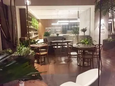 a dining room with tables and chairs and plants at Charming Bedroom - next to train station at Est Bangsar in Kuala Lumpur
