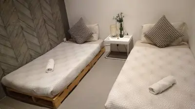 two twin beds in a room with at Charming Bedroom - next to train station at Est Bangsar in Kuala Lumpur