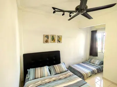 a bedroom with two beds and a ceiling fan at Setapak TerataiMewahApart to15min KLCC 217 in Kuala Lumpur