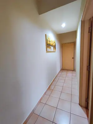 a hallway with a tile floor and a painting on the wall at Fahrenheit 88 Pavillion Bukit Bintang Street AJ-HOME in Kuala Lumpur