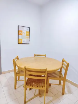 a wooden table with two chairs and a table and a wall at Fahrenheit 88 Pavillion Bukit Bintang Street AJ-HOME in Kuala Lumpur