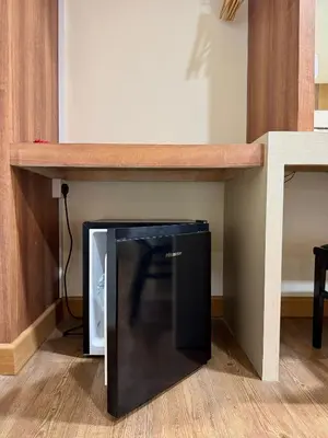 a black microwave under a counter in a room at Swiss Hotel Kuala Lumpur in Kuala Lumpur