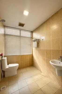 a bathroom with a toilet and a sink at Swiss Hotel Kuala Lumpur in Kuala Lumpur