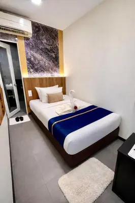 a bedroom with a large bed with a window at Swiss Hotel Kuala Lumpur in Kuala Lumpur