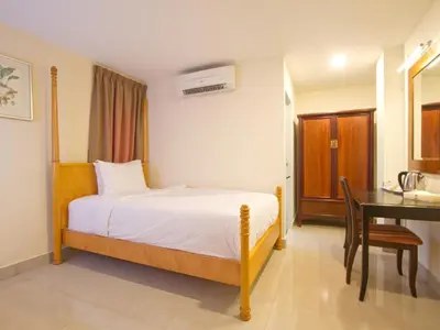 a bedroom with a bed and a desk and a desk at Lotus Hotel Masjid India in Kuala Lumpur