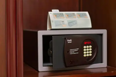 a microwave with a box on top of it at Lotus Hotel Masjid India in Kuala Lumpur