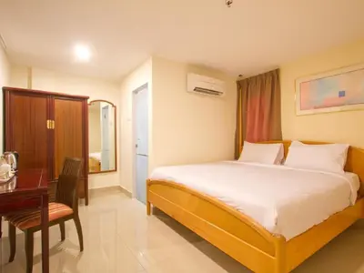 a hotel room with a bed and a table and a desk at Lotus Hotel Masjid India in Kuala Lumpur