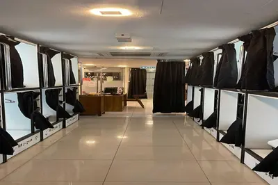 a dressing room filled with black and white shoes at OYO 91036 J CAPSULE HOTEL @ JALAN BUKIT BINTANG in Kuala Lumpur