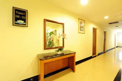 a hallway of a hospital with a counter and a mirror at Palm Inn Ampang Point in Ampang