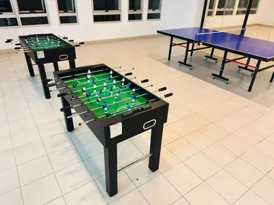 two ping pong tables in a room with chess at Taragon Service Apartment- Next To LaLaport BBCC in Kuala Lumpur