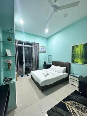 a bedroom with a bed and a blue wall at Taragon Service Apartment- Next To LaLaport BBCC in Kuala Lumpur