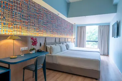 a bedroom with a bed and a desk with a chair at ibis Styles Kuala Lumpur Bukit Bintang in Kuala Lumpur