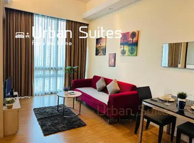 a living room with a red couch and a table at Urban Suites @ Swiss Garden Residence in Kuala Lumpur