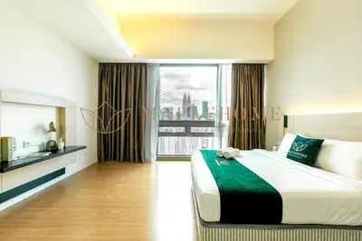 a bedroom with a large bed and a large window at SG Residence Kuala Lumpur in Kuala Lumpur