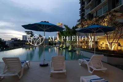 a group of chairs and umbrellas next to a swimming pool at SG Residence Kuala Lumpur in Kuala Lumpur