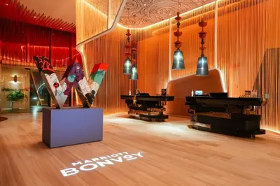 a room with wooden floors and a room with a piano at W Kuala Lumpur in Kuala Lumpur