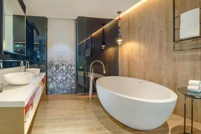 a bathroom with two sinks and a large tub at W Kuala Lumpur in Kuala Lumpur