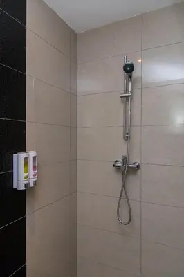 a shower with a shower head in a bathroom at Imperial Regency Suites & Petaling Jaya in Kuala Lumpur