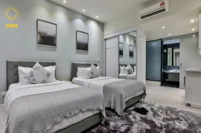 a bedroom with two beds and a bathroom at Expressionz Suites By iHost Global in Kuala Lumpur