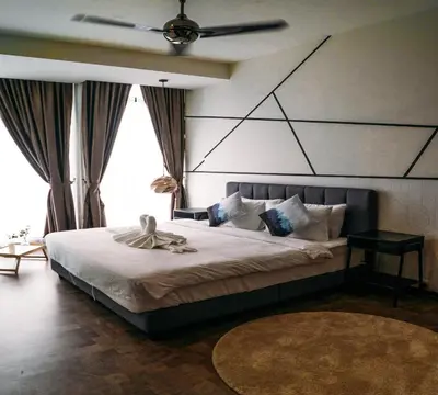 a bedroom with a large bed with a ceiling fan at Expressionz Suites By iHost Global in Kuala Lumpur