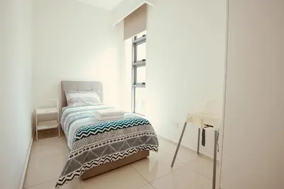 a white room with a bed and a desk at Robertson Suites Kuala Lumpur in Kuala Lumpur