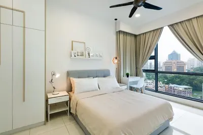 a bedroom with a bed and a large window at Robertson Suites by Airhost in Kuala Lumpur